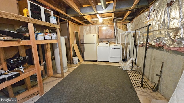 basement with white refrigerator, washing machine and dryer, and gas water heater