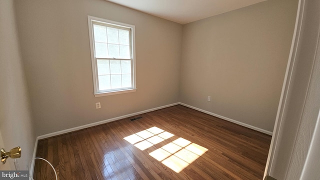 unfurnished room with dark hardwood / wood-style flooring and plenty of natural light