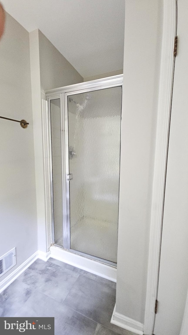 bathroom featuring concrete flooring and walk in shower