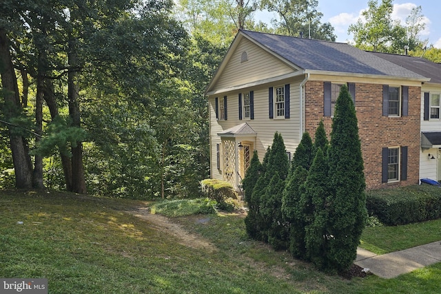 view of side of property featuring a yard