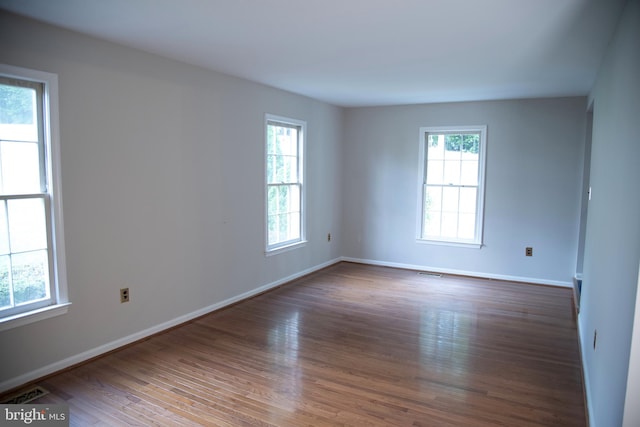 unfurnished room with dark hardwood / wood-style floors