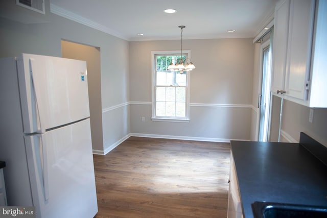 kitchen with white cabinetry, dark hardwood / wood-style flooring, white refrigerator, pendant lighting, and a chandelier