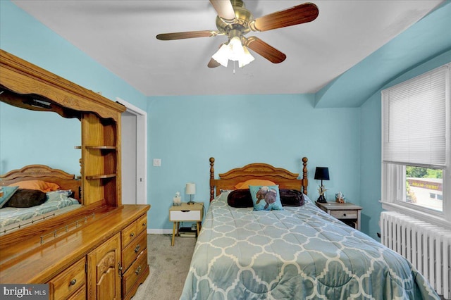 carpeted bedroom with radiator, ceiling fan, and lofted ceiling