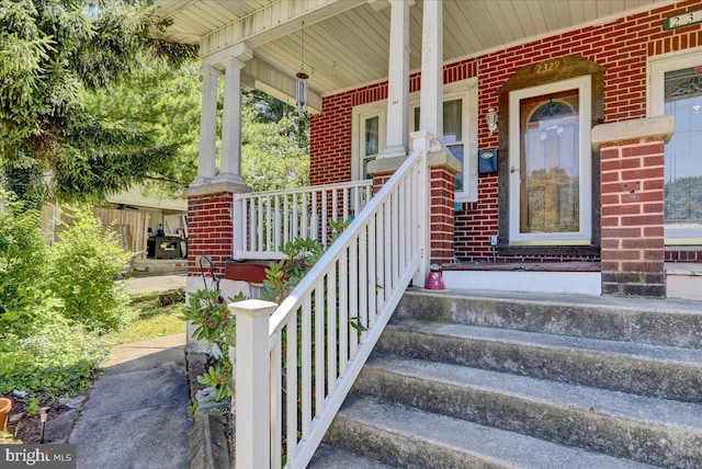 view of exterior entry with covered porch