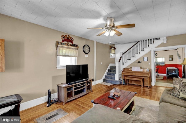 living room with ceiling fan and wood-type flooring