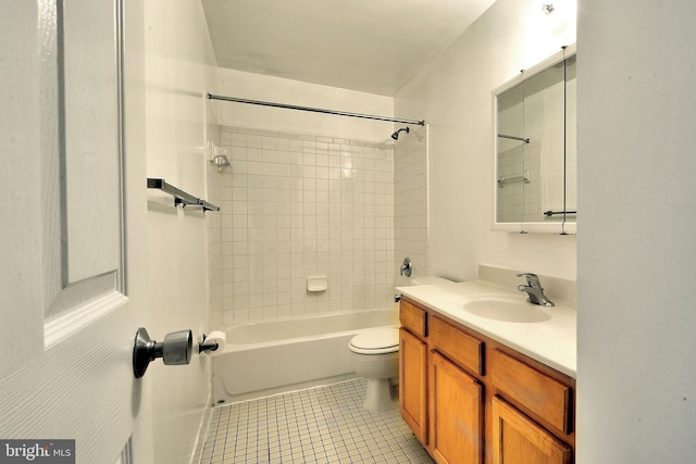 full bathroom with toilet, vanity, tiled shower / bath, and tile patterned flooring