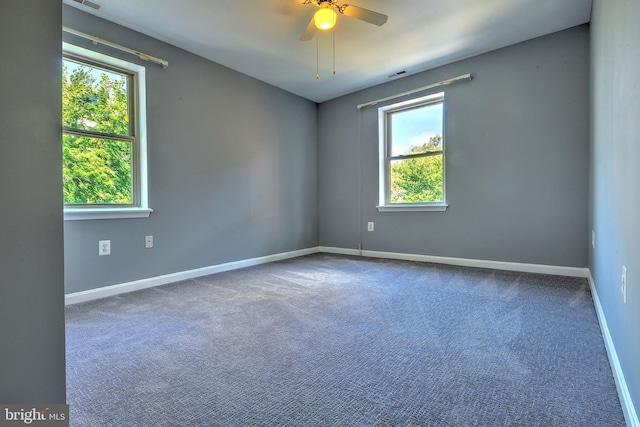 empty room with ceiling fan and carpet