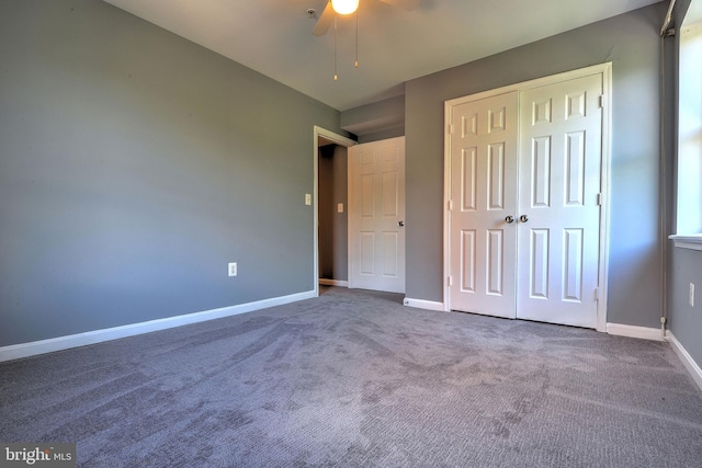 unfurnished bedroom featuring ceiling fan, a closet, and carpet flooring