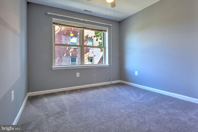 unfurnished room with ceiling fan and carpet