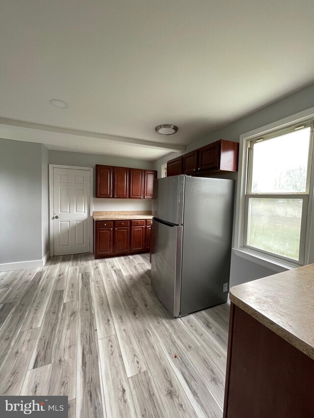 kitchen featuring light wood-type flooring and stainless steel refrigerator