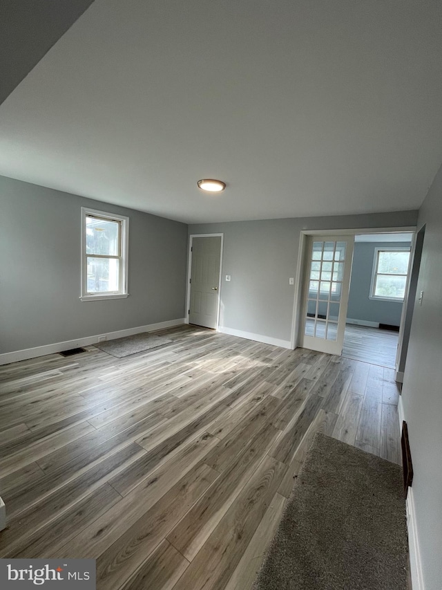 empty room featuring hardwood / wood-style floors and plenty of natural light