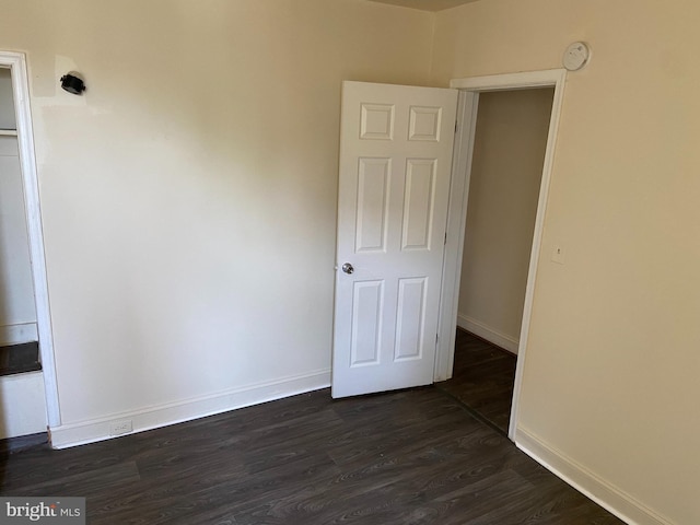 spare room featuring dark hardwood / wood-style flooring