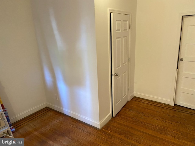 hall with dark hardwood / wood-style flooring