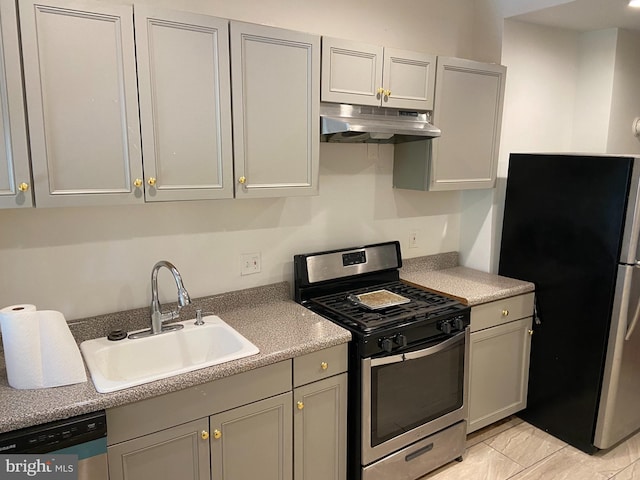 kitchen with gray cabinets, sink, light tile patterned floors, and appliances with stainless steel finishes