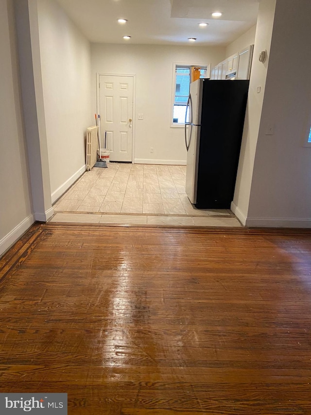 interior space featuring stainless steel fridge and light wood-type flooring