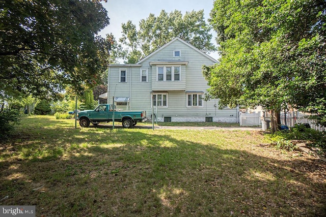 back of property featuring a lawn