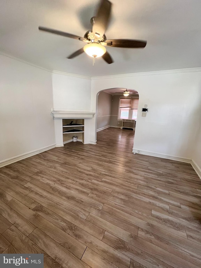 unfurnished living room featuring ornamental molding, hardwood / wood-style floors, and ceiling fan