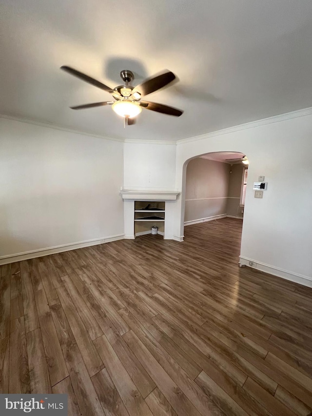 unfurnished living room featuring ceiling fan, crown molding, and dark wood-type flooring