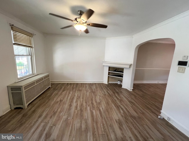 unfurnished living room featuring crown molding, radiator, ceiling fan, and hardwood / wood-style floors