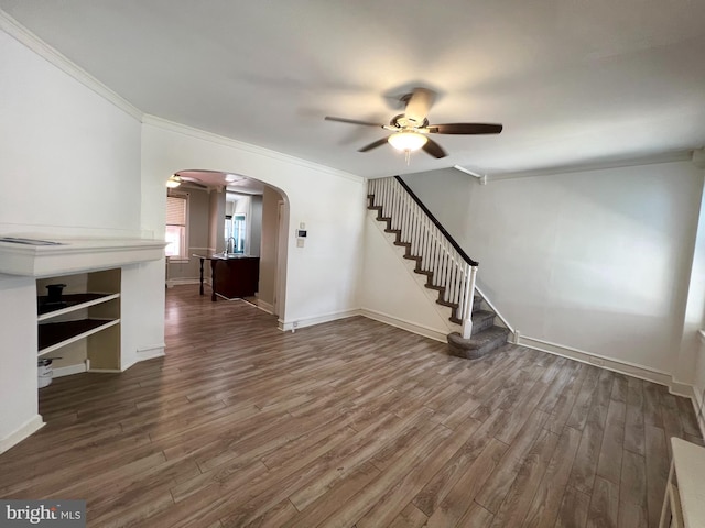 unfurnished living room featuring hardwood / wood-style flooring, ornamental molding, sink, and ceiling fan