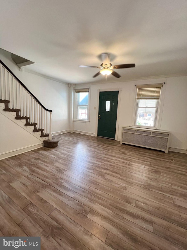 interior space featuring radiator, hardwood / wood-style flooring, and ceiling fan