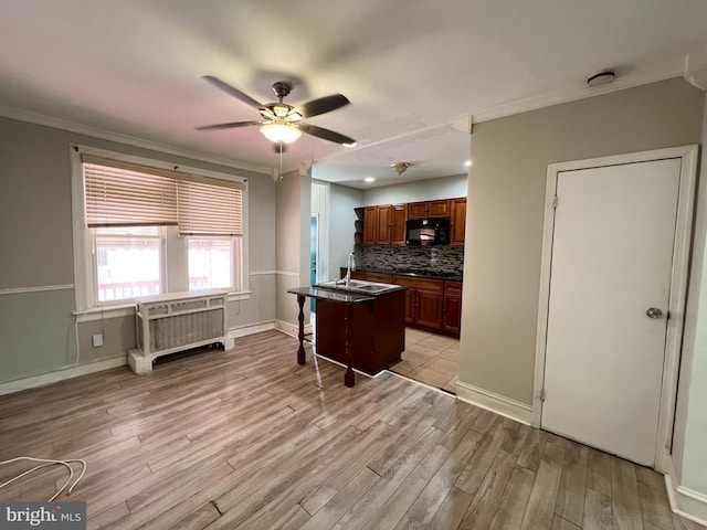 kitchen featuring black appliances, ceiling fan, sink, light tile patterned floors, and backsplash