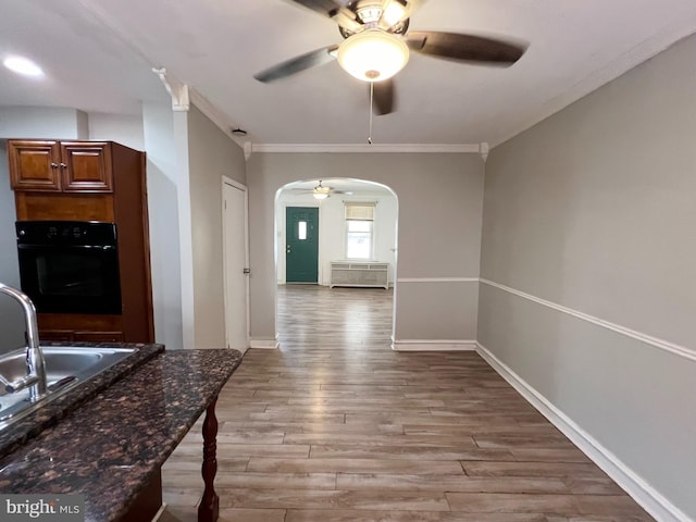 interior space featuring ornamental molding, sink, and hardwood / wood-style flooring