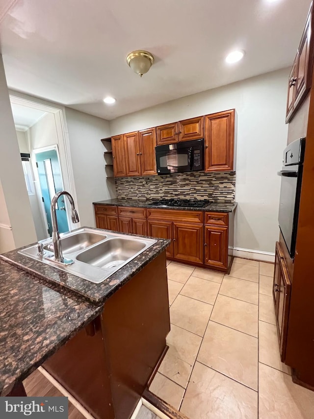 kitchen featuring gas cooktop, sink, wall oven, light tile patterned floors, and decorative backsplash