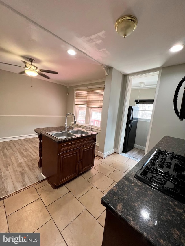 kitchen with black refrigerator, sink, plenty of natural light, and gas cooktop