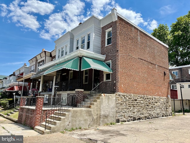 view of property featuring covered porch