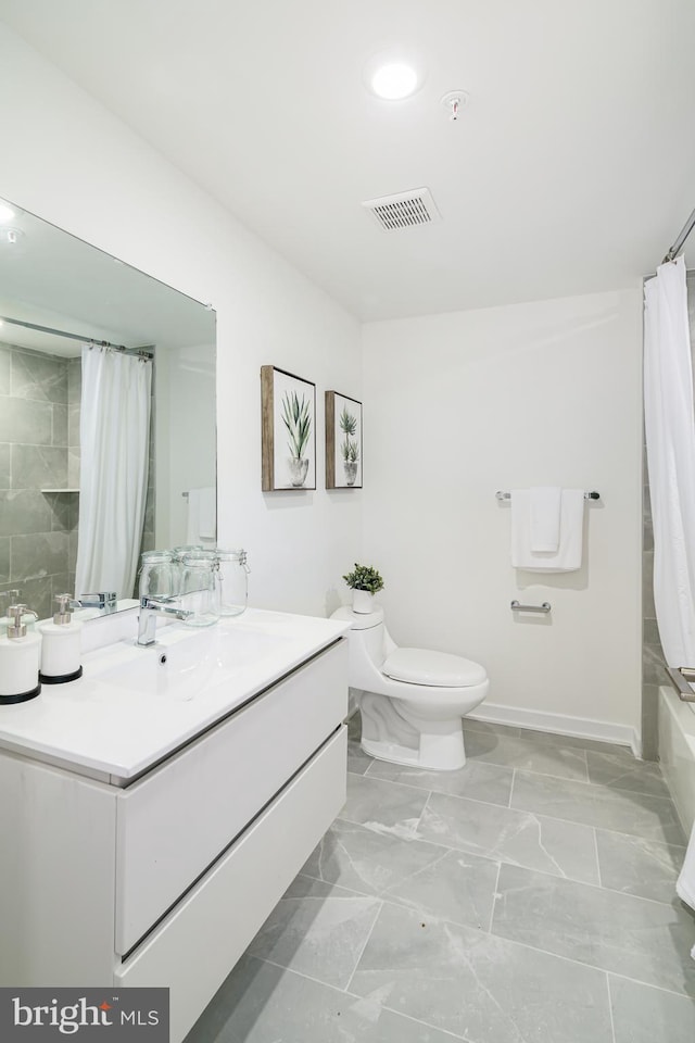 full bathroom with vanity, toilet, and shower / tub combo