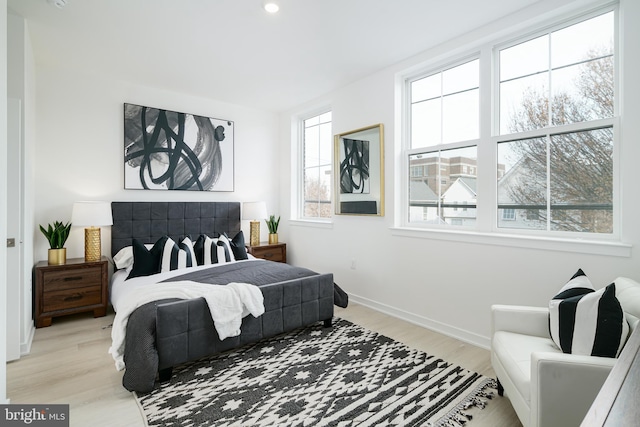 bedroom featuring light hardwood / wood-style floors and multiple windows