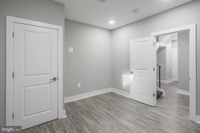 spare room featuring wood-type flooring