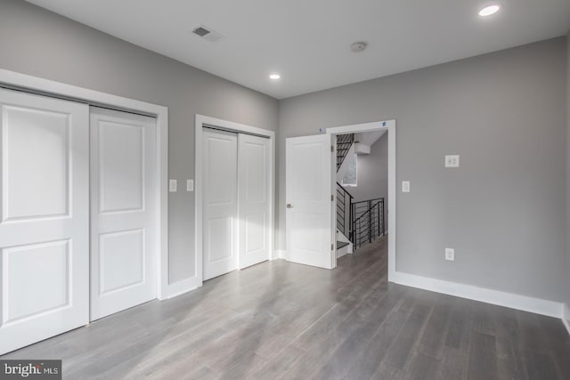 unfurnished bedroom with hardwood / wood-style flooring