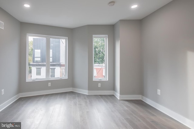 unfurnished room with light hardwood / wood-style floors and a healthy amount of sunlight