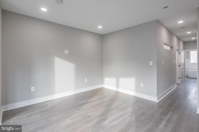 spare room featuring wood-type flooring