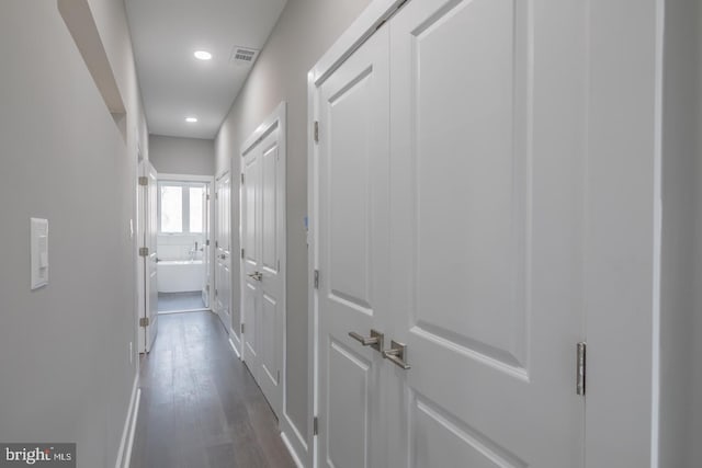 corridor featuring dark hardwood / wood-style floors