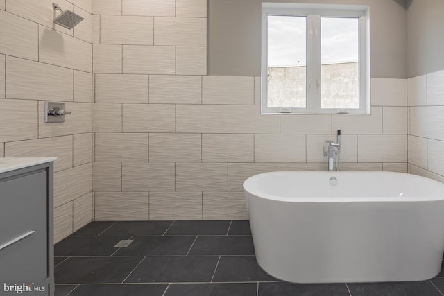 bathroom featuring tile patterned flooring, tile walls, and a bath