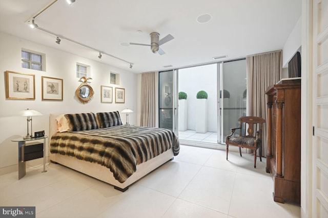 bedroom featuring access to exterior, ceiling fan, a wall of windows, track lighting, and light tile patterned flooring