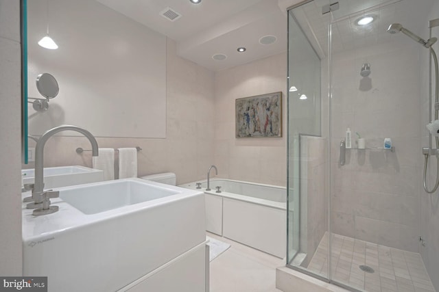 bathroom with tile patterned floors, toilet, and independent shower and bath