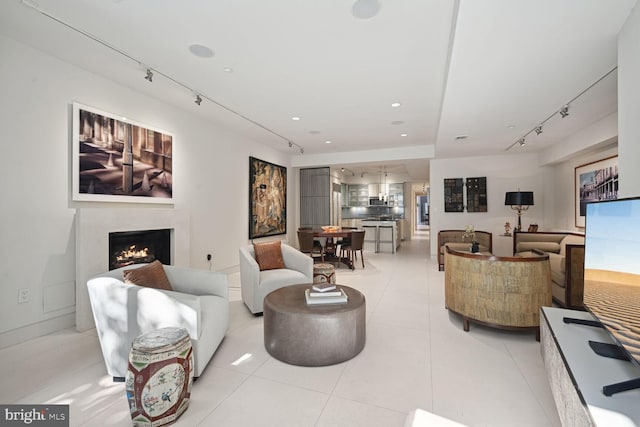 tiled living room featuring rail lighting