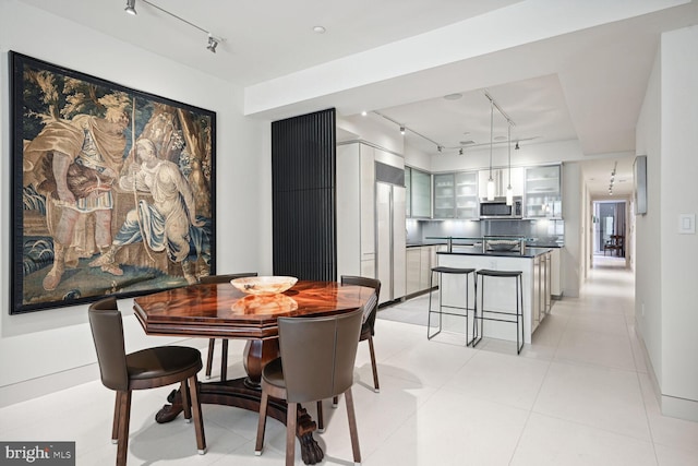 dining space featuring light tile patterned flooring