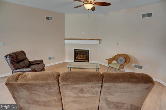 living room featuring ceiling fan and hardwood / wood-style floors