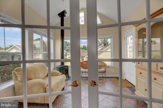 sunroom / solarium featuring vaulted ceiling