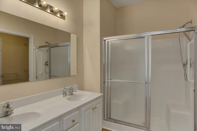 bathroom featuring an enclosed shower and vanity