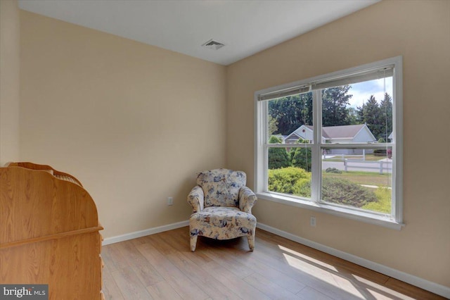 unfurnished room with light hardwood / wood-style floors and a healthy amount of sunlight