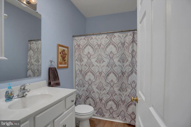 bathroom with hardwood / wood-style flooring, vanity, and toilet