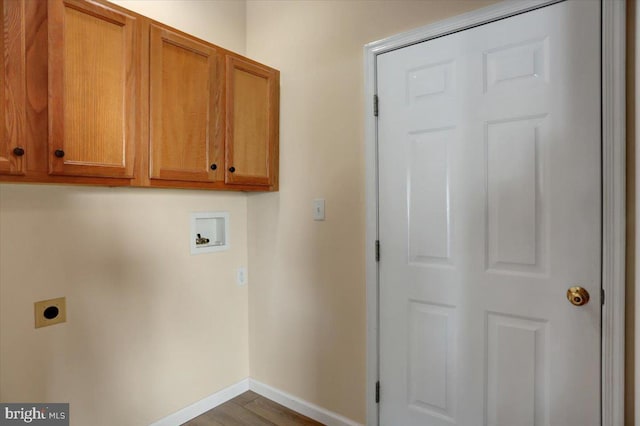 clothes washing area with cabinets, hookup for a washing machine, wood-type flooring, and hookup for an electric dryer