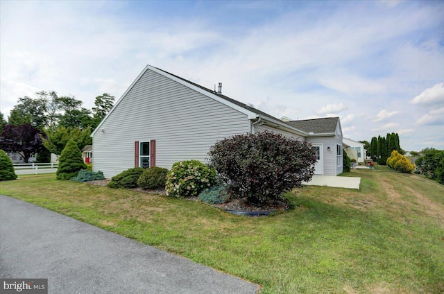 view of home's exterior with a lawn