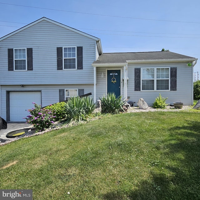 tri-level home featuring a garage and a front lawn